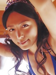 Cute asian babe in a purple bikini shows her big massive boobs