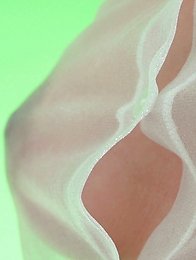 On the green screen Reina ran her hands across her see through outfit