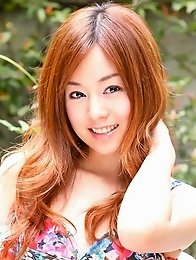 Red headed asian cutie posing in a floral printed dress