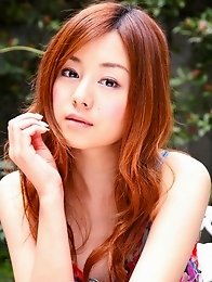 Red headed asian cutie posing in a floral printed dress