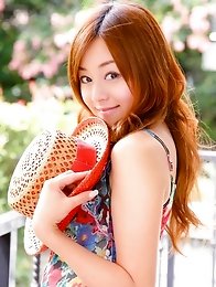 Red headed asian cutie posing in a floral printed dress