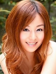 Red headed asian cutie posing in a floral printed dress