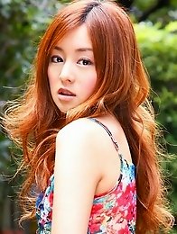 Red headed asian cutie posing in a floral printed dress