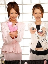 Yuri and Yu posing with sex toys