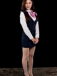 Flight attendant Yuu Kazuki posing in uniform, getting teased by a vibrator