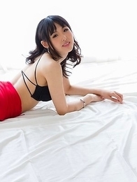 Natsuki Yokoyama posing in a red skirt with black stockings, showing her ass
