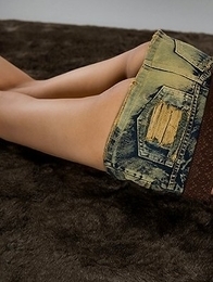 Karina Oshima posing in her sexy skirt before going down on the floor to masturbate