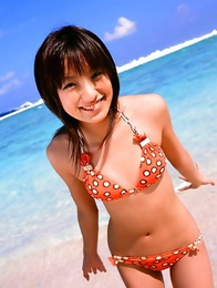 Akina Minami in colorful bath suits plays with big ball