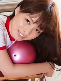 Maho Kiruma in sports equipment plays with ball on desk